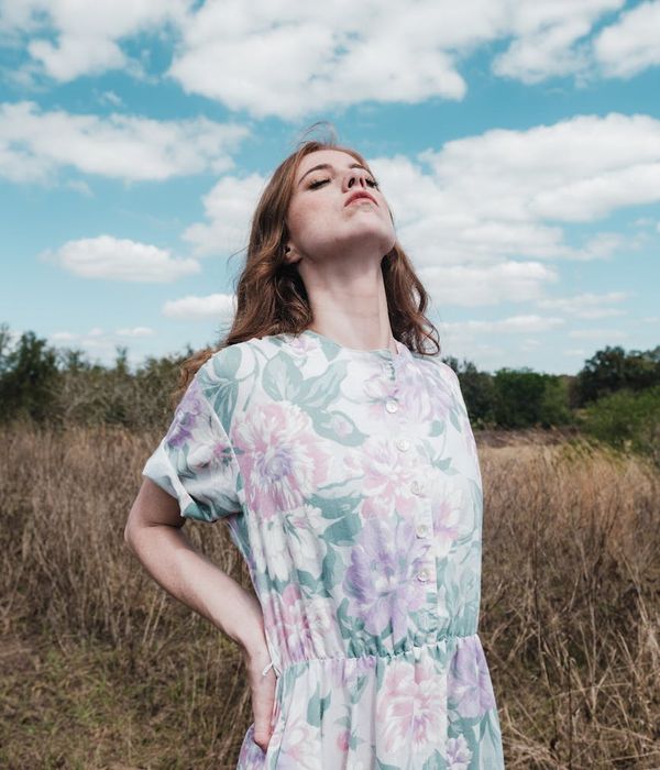 Person stretching outdoors with a serene natural background.